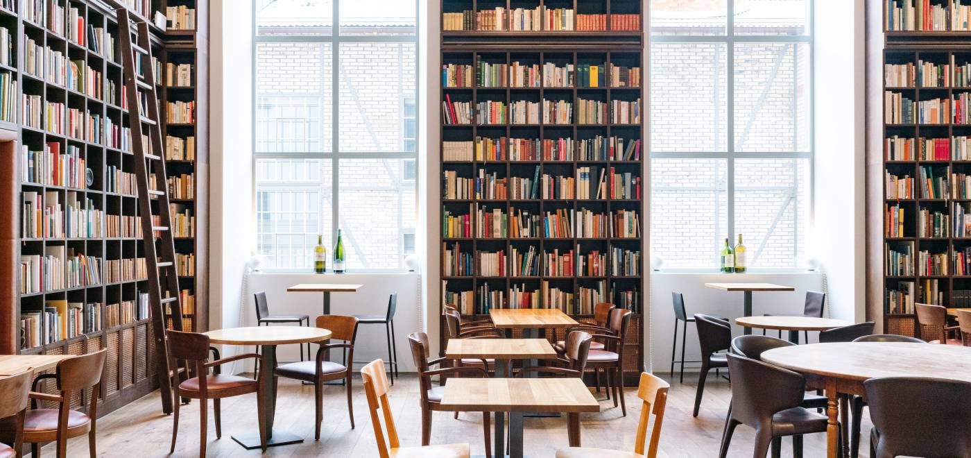 Tables and chairs in the library at the B2 Hotel Zurich