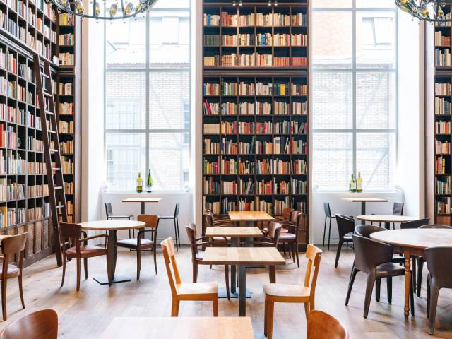 Tables and chairs in the library at the B2 Hotel Zurich