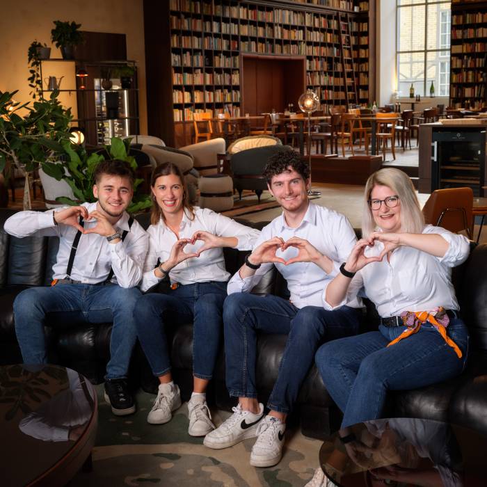 Team of Guest Ambassadors of the B2 Hotel making hearts with their hands